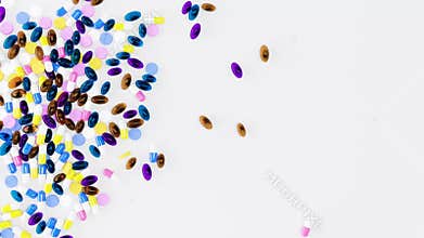 Scatter the tablets, pills, and capsules onto a flat white surface. Free space template on the right side for your content