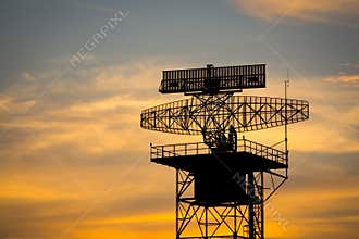 Silhouette radar tower plane and twilight sky
