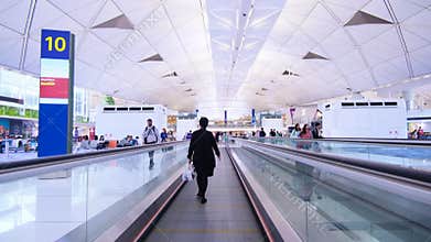 Busy airport . Hong Kong. On Electric Walkway.