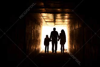 Family holding hands in the tunnel