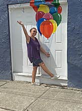 senior adult woman holding balloons