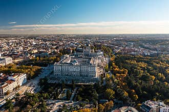 Aerial view of majestic building of Palacio Real de Madrid. Historic Royal palace and cityscape in golden hour. Madrid
