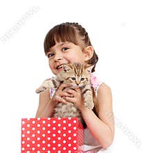 Happy child girl takes cat out gift box