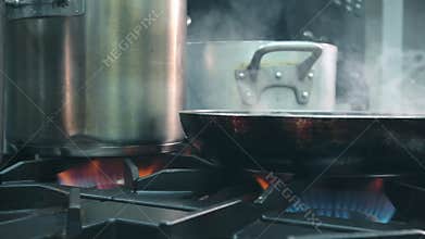 Pots and pans on the stove in the restaurant kitchen