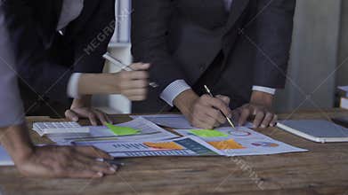 Business team meeting to analyze and discuss the financial report situation in