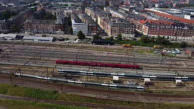 Aerial drone footage of an s-train heading towards Copenhagen's main train station, Denmark