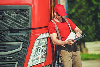 Truck Driver Checking Cargo Shipping Documents