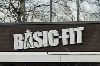 Basic-Fit white logo at the gym. Basic-Fit is the largest fitness chain in Europe.