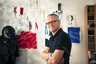 Happy mature man working as fashion designer