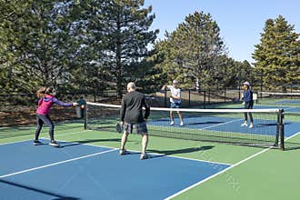 Men and Women in a Doubles Game of Pickleball