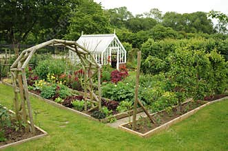 Greenhouse and garden arch in a garden