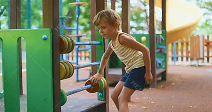 Child Playing with Abacus at Playground on a Sunny Day