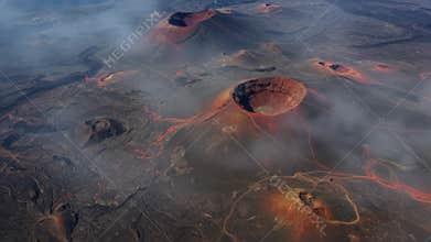 Aerial View of Active Volcano with Red Lava Flowing Across Black Volcanic Land