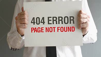 Businessman holding paper with 404 Error - Page not found title.