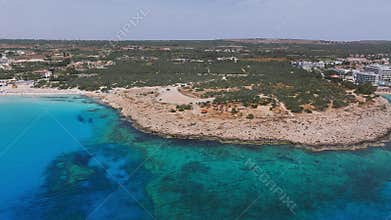 Aerial view of Ayia Napa coastline with resorts and turquoise waters
