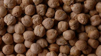 Raw Chickpeas on a rustic wooden table. Dry chickpea background close up. Chickpea legumes seed background.