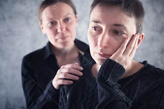 Comforting friend. Woman consoling her sad friend.