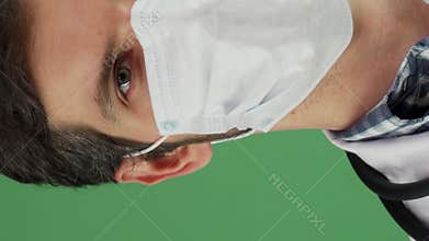 Confident male doctor in a medical mask exuding joy and professionalism