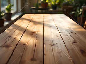 Empty rustic wooden table surface with warm sunlight and blurred plant background