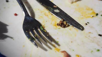 Dirty plate with leftover food and utensils after a meal