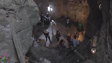 Group explores ancient cave with unique rock formations and artifacts