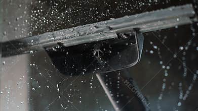 The remaining water on the glass is removed with a rubber scraper.