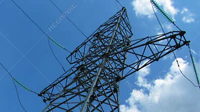 tall electric masts against cloudy sky - zoom timelapse