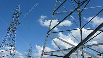 tall electric masts against cloudy sky - timelapse
