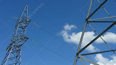 tall electric masts against cloudy sky - zoom timelapse