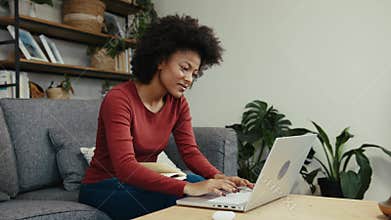 African American university teacher setting up an assignment for her students on a laptop