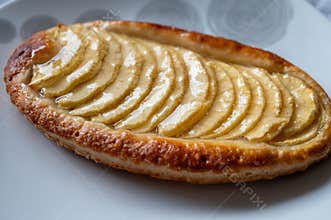 French fresh baked sweet puff pastry with fresh apple fruits in sirup in confectionery shop