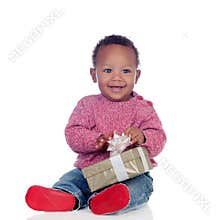 Adorable African American child playing with a gift box