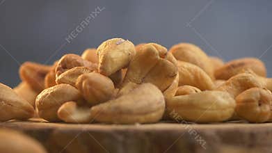 slow motion of falling cashew nuts on a wooden table