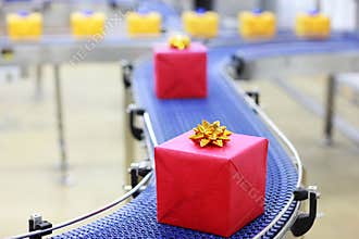 Gifts on conveyor belt in Christmas presents facto