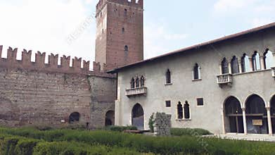 Tourists exploring historic castle in verona, italy, with medieval architecture