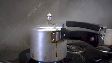 Pressure Cooker Whistling in Indian Kitchen: Releasing Hot Steam