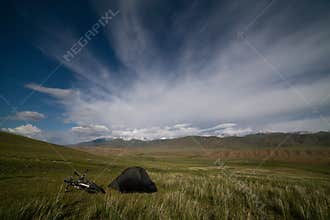 Tent in mountains under star sky