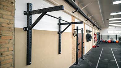 A simple wallmounted pullup bar is prominently positioned immediately capturing attention and emphasizing the gyms