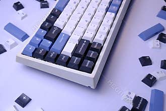 Close Up Modern 75% Layout Mechanical Keyboard with White, Blue, and Black Keycaps on a Clean White Desk