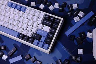 Modern 75% Layout White Mechanical Keyboard With Minimalist Theme of White, Blue, and Black Keycaps on a Minimal Blue Deskmat