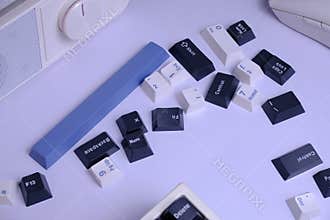 Scattered PBT Doubleshot Keycaps on a Clean White Desk, Coloured White, Blue, and Black