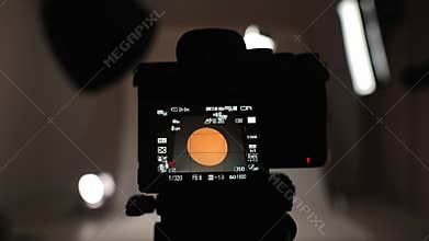 Professional studio for photo and video filming with modern lighting equipment, large white cyclorama, photographer videographer