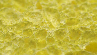 Cellulose sponge rotating in circle. Abstract background texture macro