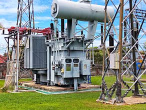 A transformer with a very complicated electricity network and electricity poles around it
