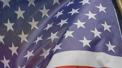 The USA national flag and the Rainbow LGBT flag soar high in bright sky