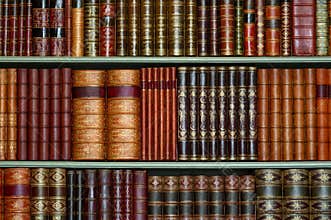 Old library of vintage hard cover books on shelves