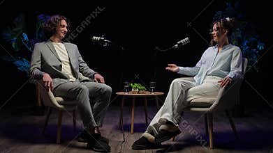Engaging Podcast Discussion Between Two Influencers in a Modern Recording Studio Setup