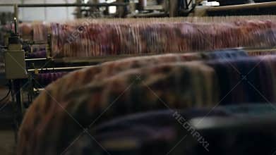 Textile factory. Weaving machines, spinning machines, finished fabrics are shown.