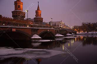 Oberbaumbruecke bridge and river Spree in winter, Berlin, Germany.