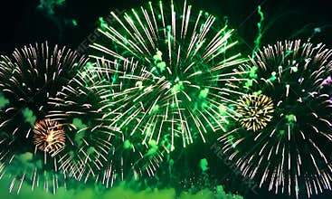 fireworks background. the abstract blur of golden shining fireworks with bokeh lights in the night sky. glowing fireworks show